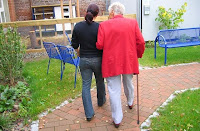 Senior and caregiver on a walk