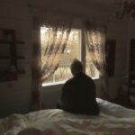 Lonely senior man looking out of window