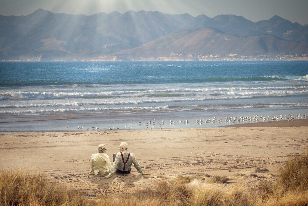 Elderly couple enjoying sunshine on a beach