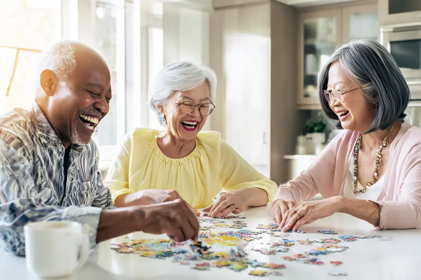 3 elders doing a puzzle together